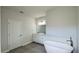A bathroom with a white vanity, double sinks, a free standing tub and tiled floors at 2500 Sw 156Th Ln Rd, Ocala, FL 34473