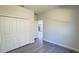 Neutral bedroom with large closet and grey flooring; adjacent room visible through doorway at 2500 Sw 156Th Ln Rd, Ocala, FL 34473
