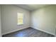 Neutral bedroom with grey flooring and large window with a view of the outdoors at 2500 Sw 156Th Ln Rd, Ocala, FL 34473