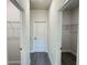 Hallway with doors to closet and other rooms and laminate wood flooring at 2500 Sw 156Th Ln Rd, Ocala, FL 34473