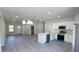Bright, open-concept kitchen with white cabinets, stainless steel appliances, and an island with seating at 2500 Sw 156Th Ln Rd, Ocala, FL 34473