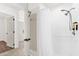Bathroom featuring shower with dispenser and grab bar, and a view to the hallway at 2513 Hickory Oak Blvd, Orlando, FL 32817