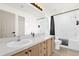 Bright bathroom featuring double sinks, wood cabinets, and a shower and tub combination at 2513 Hickory Oak Blvd, Orlando, FL 32817