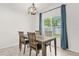 Cozy dining area featuring a modern chandelier and a backyard view at 2513 Hickory Oak Blvd, Orlando, FL 32817