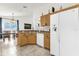 Kitchen with wood cabinets and a breakfast bar open to the dining area at 2513 Hickory Oak Blvd, Orlando, FL 32817