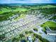 Aerial view of a community, showing houses, roads, and green spaces at 2932 Whispering Trails Dr, Winter Haven, FL 33884