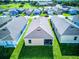 Aerial view of a home's backyard and neighboring houses in a well-maintained community at 2932 Whispering Trails Dr, Winter Haven, FL 33884