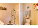 Bright bathroom with a glass-enclosed shower, toilet, and decor at 2932 Whispering Trails Dr, Winter Haven, FL 33884
