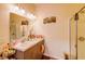 Bright bathroom featuring double sinks, a shower, a large mirror, and tasteful decor at 2932 Whispering Trails Dr, Winter Haven, FL 33884