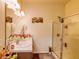 Bathroom featuring double sinks, shower, large mirror, and tasteful decor at 2932 Whispering Trails Dr, Winter Haven, FL 33884