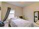 Cozy bedroom with a bed, side table, and large window offering plenty of natural light at 2932 Whispering Trails Dr, Winter Haven, FL 33884