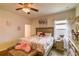 Inviting bedroom featuring a ceiling fan, and a quaint window at 2932 Whispering Trails Dr, Winter Haven, FL 33884