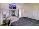 A minimalist bedroom with stylish decor and a sleek television mounted at 2932 Whispering Trails Dr, Winter Haven, FL 33884