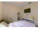 Compact bedroom with a television and floating shelves above the bed at 2932 Whispering Trails Dr, Winter Haven, FL 33884