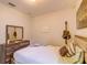 Bedroom featuring a bed with decorative pillows, a wooden dresser, and a guitar on the wall at 2932 Whispering Trails Dr, Winter Haven, FL 33884