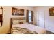 Cozy bedroom featuring a cityscape print and a comfortable bed with decorative pillows at 2932 Whispering Trails Dr, Winter Haven, FL 33884