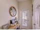 Hallway with white walls, console table, decor, and back door with blind inserts at 2932 Whispering Trails Dr, Winter Haven, FL 33884