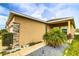 Attractive exterior featuring stone accents, a well-maintained lawn, and a neatly paved walkway at 2932 Whispering Trails Dr, Winter Haven, FL 33884