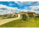 Charming single-Gathering home with a well-manicured lawn, driveway, and pleasing landscaping at 2932 Whispering Trails Dr, Winter Haven, FL 33884