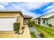 Inviting front exterior with a well-kept lawn, decorative stone accents, and an attached two-car garage at 2932 Whispering Trails Dr, Winter Haven, FL 33884