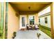 Cozy front porch with seating, plants, and a welcoming entrance to the home at 2932 Whispering Trails Dr, Winter Haven, FL 33884