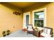 Charming front porch featuring seating, plants, and a welcoming entrance to the home at 2932 Whispering Trails Dr, Winter Haven, FL 33884
