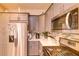 Well-lit kitchen showcases gray cabinets, stainless steel appliances, and a stylish tile backsplash at 2932 Whispering Trails Dr, Winter Haven, FL 33884