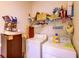 Functional laundry room features a washer, dryer, storage shelves, and cleaning supplies at 2932 Whispering Trails Dr, Winter Haven, FL 33884