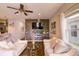Bright living room featuring neutral tones, a modern ceiling fan, and a decorative accent wall at 2932 Whispering Trails Dr, Winter Haven, FL 33884