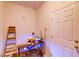 Office space with a desk, chair, computer, and a ladder against a white wall at 2932 Whispering Trails Dr, Winter Haven, FL 33884