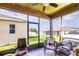 Enclosed patio with wicker furniture, ceiling fan, and view of the backyard at 2932 Whispering Trails Dr, Winter Haven, FL 33884