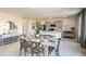 Open-concept dining area with a kitchen featuring a large island and modern appliances at 325 Cornerstone Dr, Groveland, FL 34736