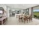 Open dining area connected to modern kitchen with island seating and stainless appliances at 325 Cornerstone Dr, Groveland, FL 34736