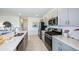 Modern kitchen features stainless steel appliances, gray cabinets, and quartz countertops at 325 Cornerstone Dr, Groveland, FL 34736