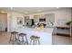 Bright kitchen featuring a large island with seating, modern appliances and gray cabinets at 325 Cornerstone Dr, Groveland, FL 34736