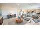 Open-concept living room with contemporary furnishings, seamlessly connecting to the kitchen at 325 Cornerstone Dr, Groveland, FL 34736