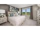Serene main bedroom with soft lighting, a plush bed, and a view of the outdoors at 325 Cornerstone Dr, Groveland, FL 34736