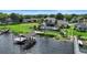 Lakefront property featuring a spacious lawn, private pool, and a charming boat house at 3604 Shell Cove Ln, Orlando, FL 32817