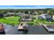 Beautiful backyard with a pool, lush green lawn, and a private dock on the lake at 3604 Shell Cove Ln, Orlando, FL 32817