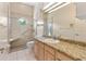 Bright bathroom featuring granite countertop, glass enclosed shower, and modern fixtures at 3604 Shell Cove Ln, Orlando, FL 32817