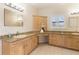 Bathroom featuring granite countertops, custom cabinets, and ample natural light at 3604 Shell Cove Ln, Orlando, FL 32817