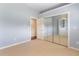 Bedroom featuring neutral carpet, mirrored closet doors, and a door to the ensuite at 3604 Shell Cove Ln, Orlando, FL 32817