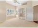 Bright bedroom featuring neutral carpet, plantation shutters on the windows, and a mirrored closet at 3604 Shell Cove Ln, Orlando, FL 32817