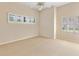 Bright bedroom featuring neutral carpet, plantation shutters on the windows, and a ceiling fan at 3604 Shell Cove Ln, Orlando, FL 32817