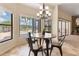 Bright breakfast nook with a view of the pool and waterfront, features a modern chandelier at 3604 Shell Cove Ln, Orlando, FL 32817