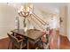 Formal dining room with hardwood floors, a large wooden table, and an elegant chandelier at 3604 Shell Cove Ln, Orlando, FL 32817