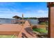 Picture of long wooden dock with a covered boathouse on a serene lake at 3604 Shell Cove Ln, Orlando, FL 32817