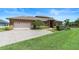 Brick home featuring a well-maintained lawn, attached garage, and carefully trimmed landscaping at 3604 Shell Cove Ln, Orlando, FL 32817