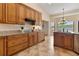 Bright kitchen featuring wooden cabinetry, granite countertops, and a center island at 3604 Shell Cove Ln, Orlando, FL 32817
