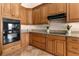 Kitchen featuring wooden cabinetry, granite countertops, and modern appliances at 3604 Shell Cove Ln, Orlando, FL 32817